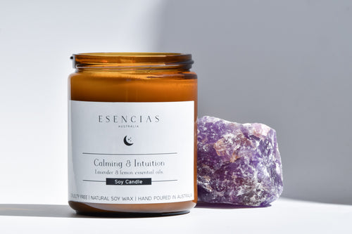 Esencias Calming and Intuition soy candle paired with amethyst crystal for a soothing energy ritual