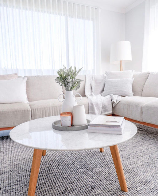 Candle styled in a cozy living room lifestyle setting, creating a warm and inviting atmosphere.