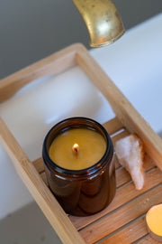 Revitalise and Cleanse candle with Citrine crystal styled in a bath setting, evoking clarity, renewal and uplifting energy.