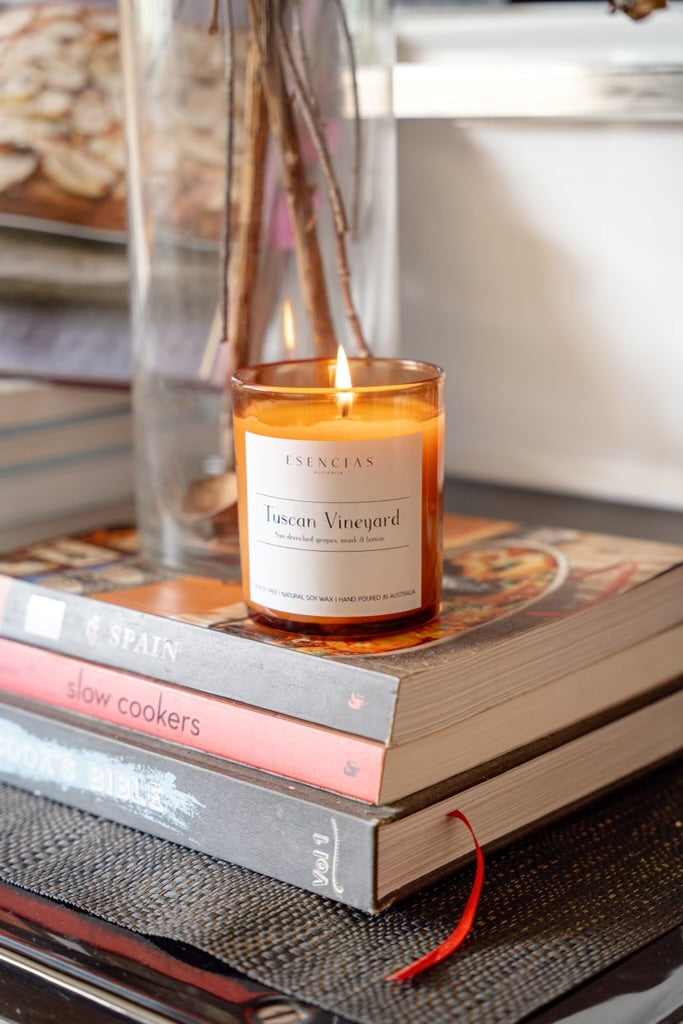 Tuscan Vineyard candle in signature amber jar styled in a warm lifestyle setting, evoking rustic charm and cozy elegance.