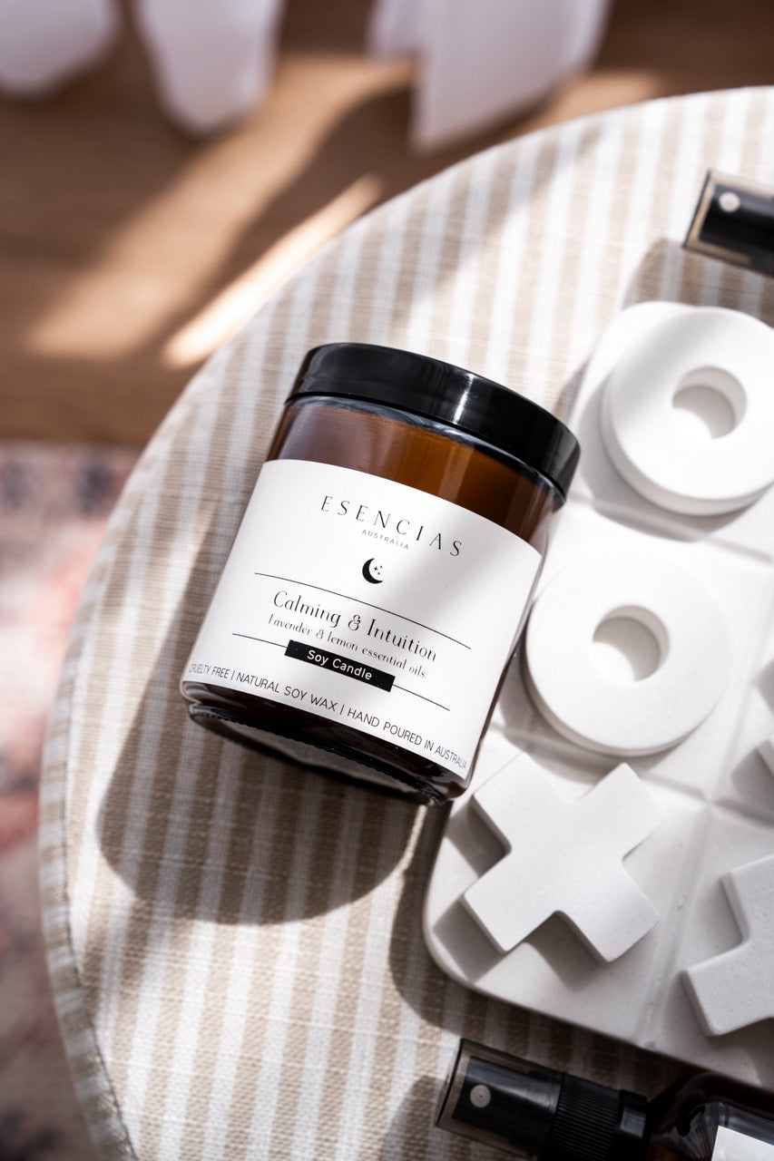 Calming & Intuition soy candle styled with sun and playful decor. 