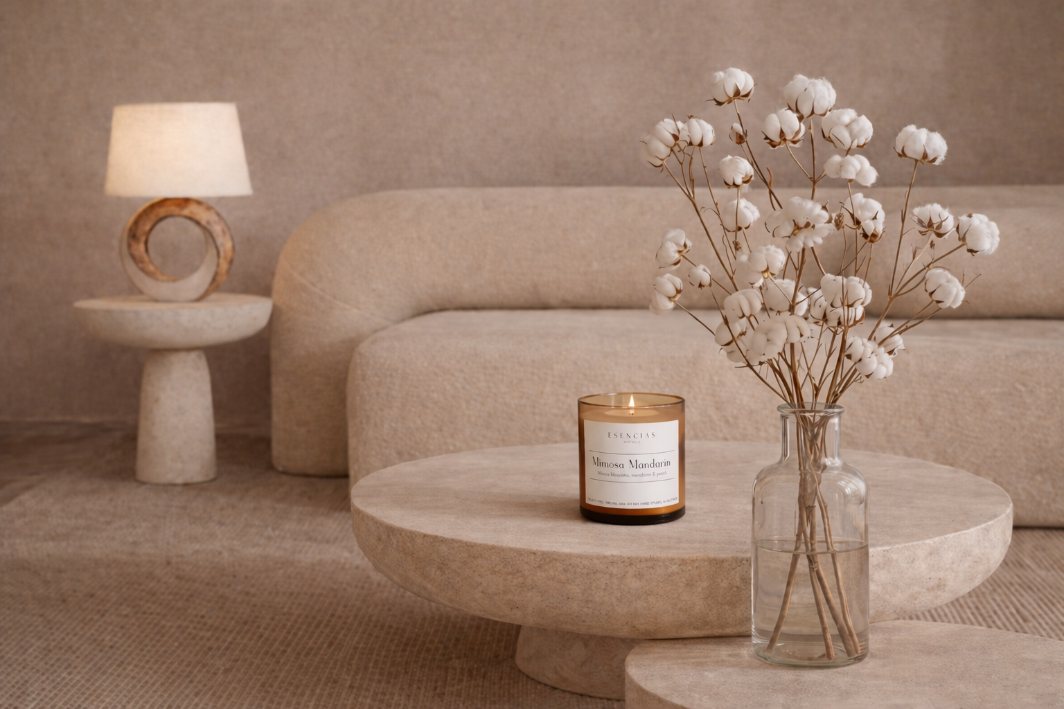Modern living room with a beige sofa, stone coffee table, and decorative elements.