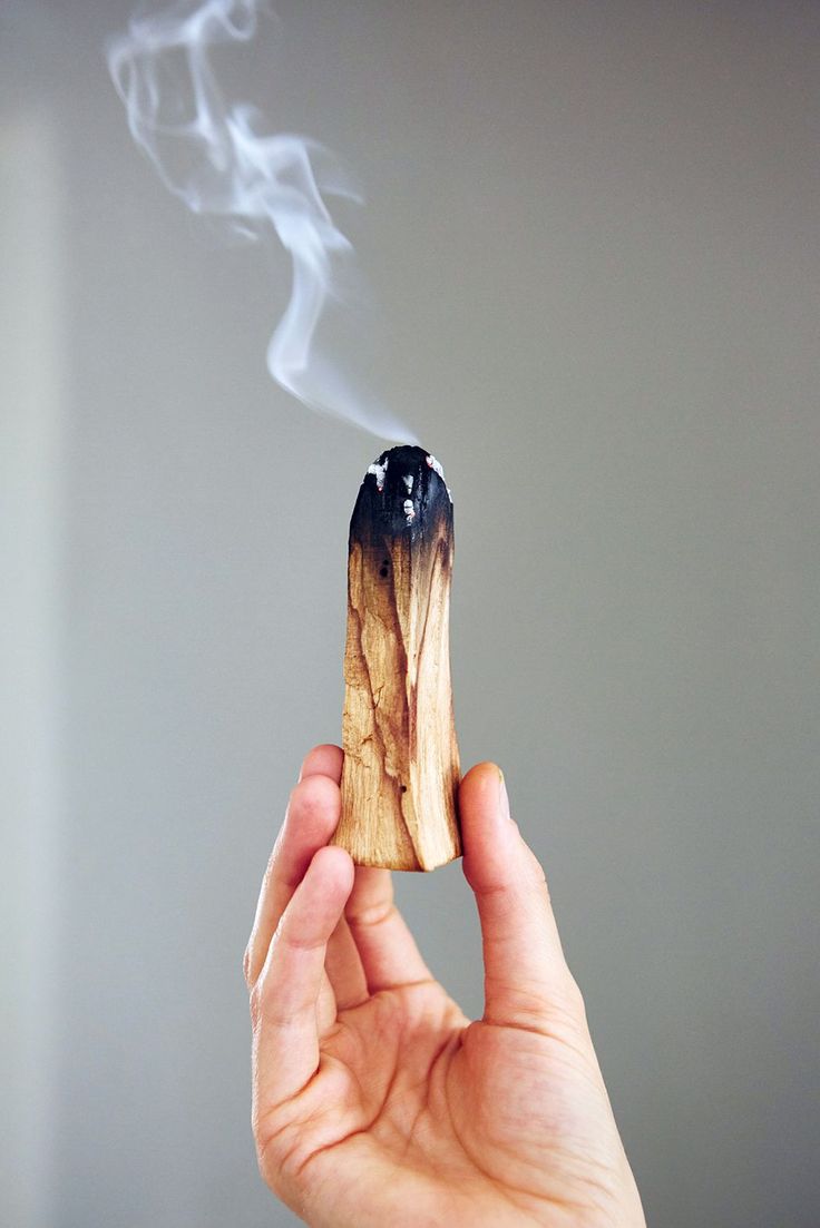 Palo Santo stick burning for cleansing ritual. 