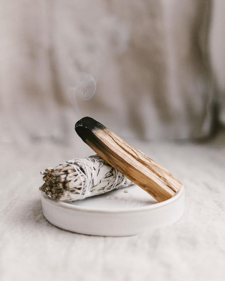 White sage bundle and palo santo stick for cleansing rituals. 