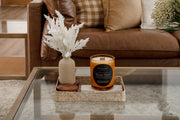 Signature Luxe Candle in Havana Sunset styled in living room with earthy decor. 