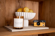 Signature Soy Candle Tuscan Vineyard in lifestyle shot with amber decor. 
