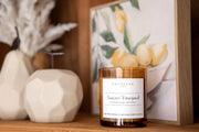 Signature Soy Candle Tuscan Vineyard in lifestyle image on shelf with candle as focal point. 