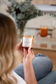 Signature collection tuscan vineyard soy candle held by model 