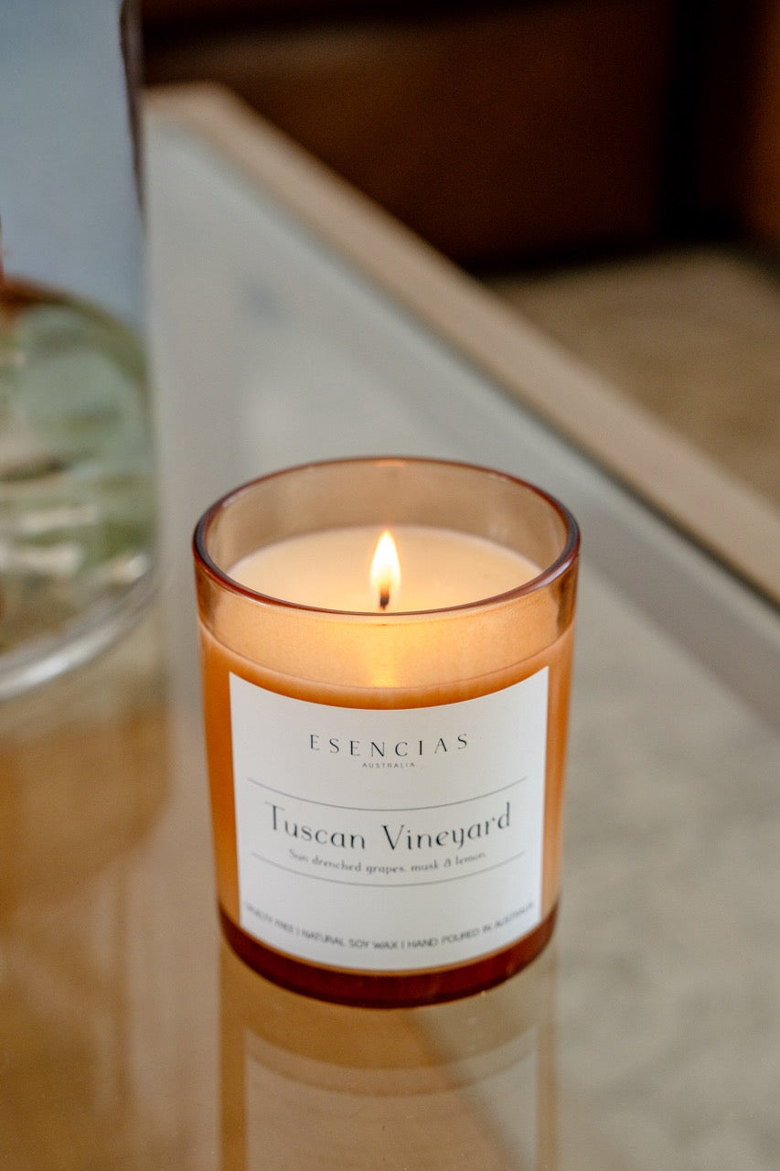 Lit candle of the tuscan vineyard in the signature range 