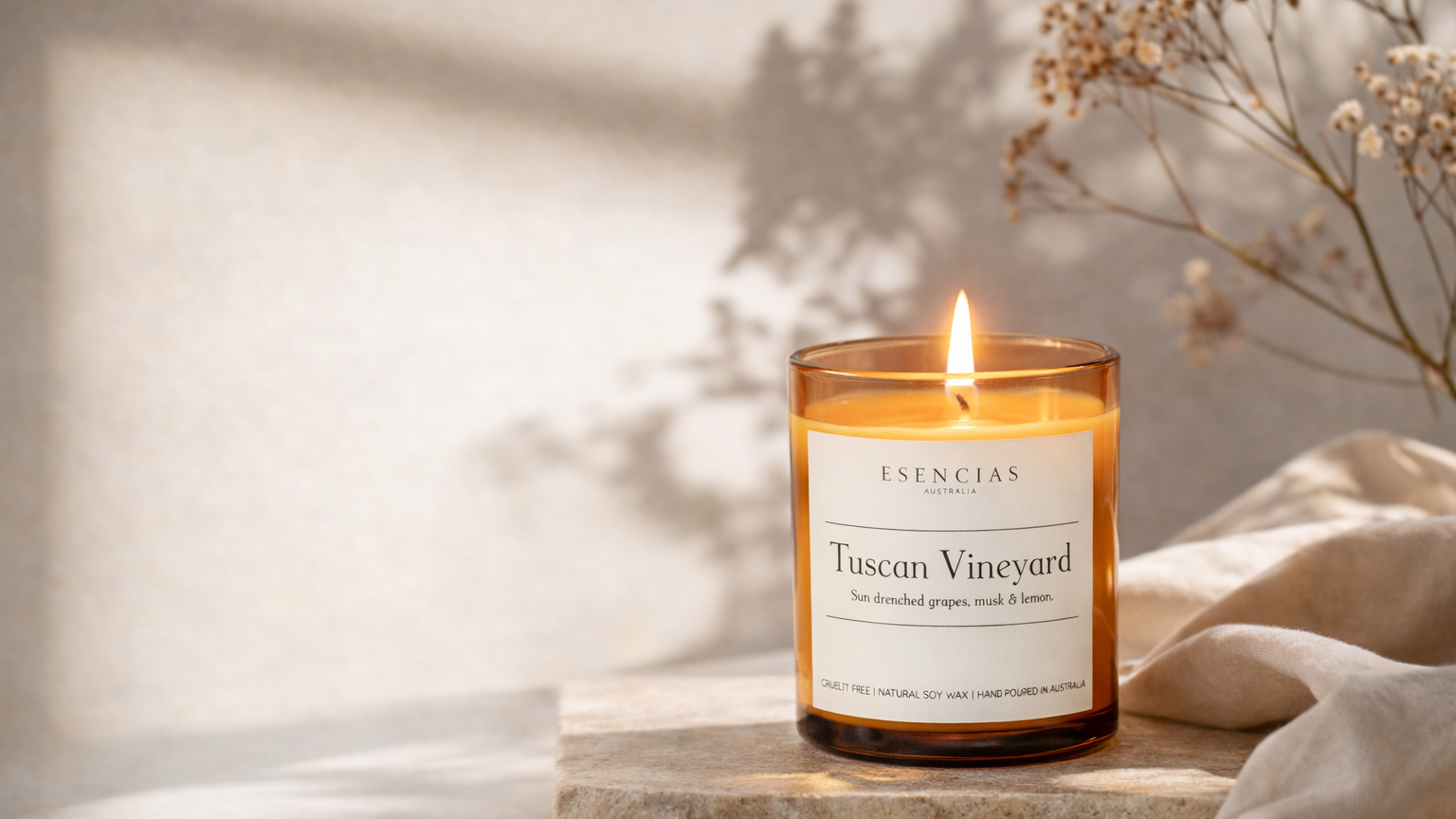 Candle labeled 'Tuscan Vineyard' on a stone surface with a soft background