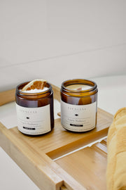 Angelic Radiance soy candle and soak scrub resting on a wooden tray over a bathtub – an Australian-made self-care ritual