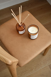 Blood Orange candle and reed diffuser styled in a vibrant lifestyle setting, evoking fresh, zesty energy and a warm, inviting atmosphere.