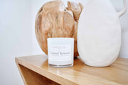Coastal Retreat soy candle styled in a peaceful coastal lifestyle setting, evoking relaxation and ocean breeze serenity.