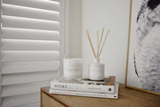 Havana Sunset coastal soy candle styled in a serene lifestyle setting, evoking warmth and beachside calm.
