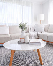 Candle styled in a cozy living room lifestyle setting, creating a warm and inviting atmosphere.