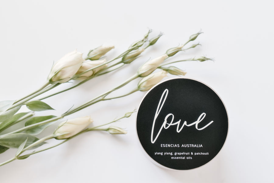 Love Edition candle styled with fresh flowers, creating a romantic and delicate image.