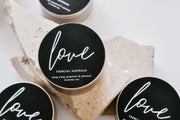 Multiple Love Edition candles displayed together in a product-focused image, showcasing their elegant design.