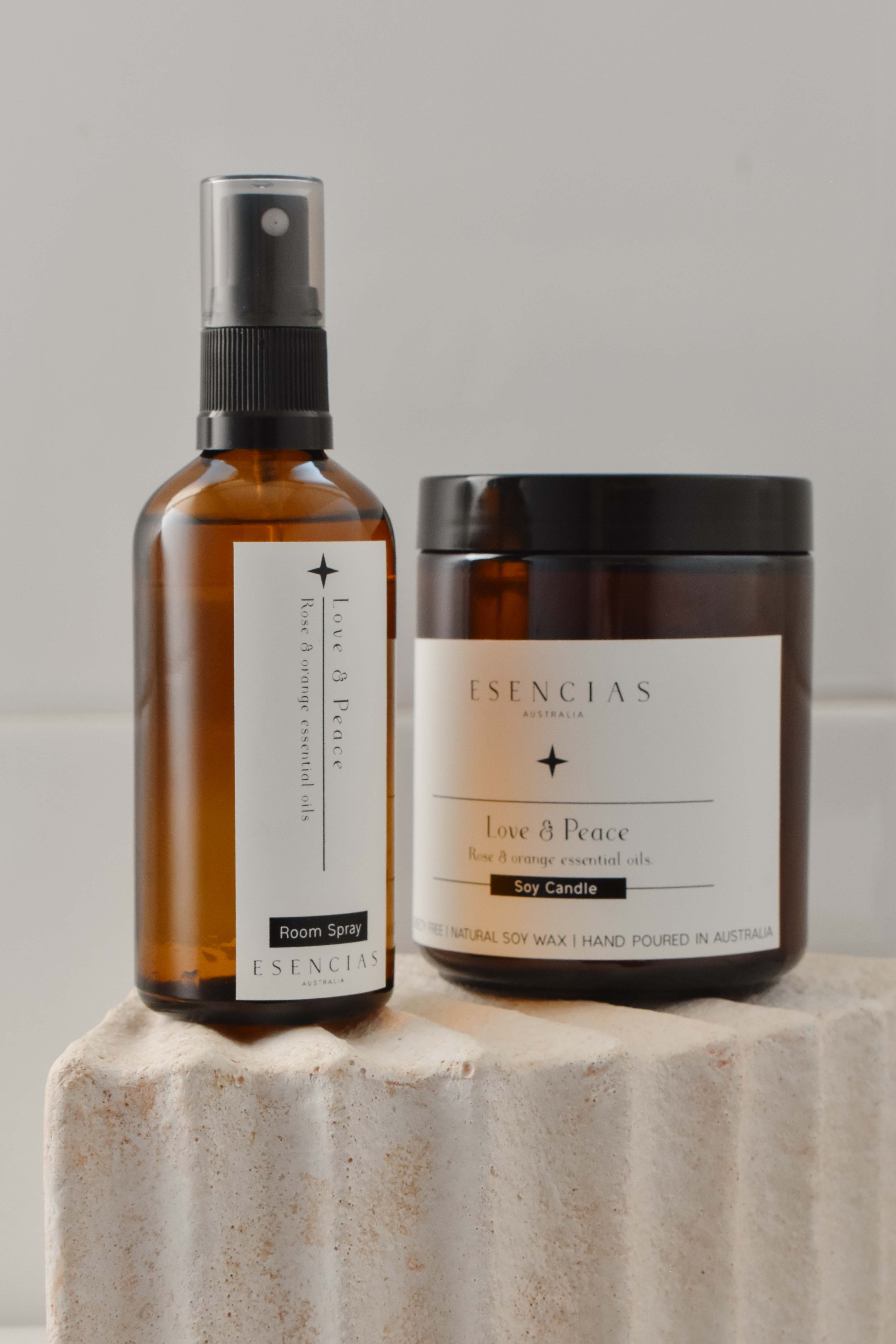 Product-focused display of the Love and Peace candle and room spray, showcasing their refined packaging and calming, nurturing essence.