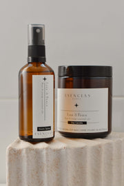 Product-focused display of the Love and Peace candle and room spray, showcasing their refined packaging and calming, nurturing essence.