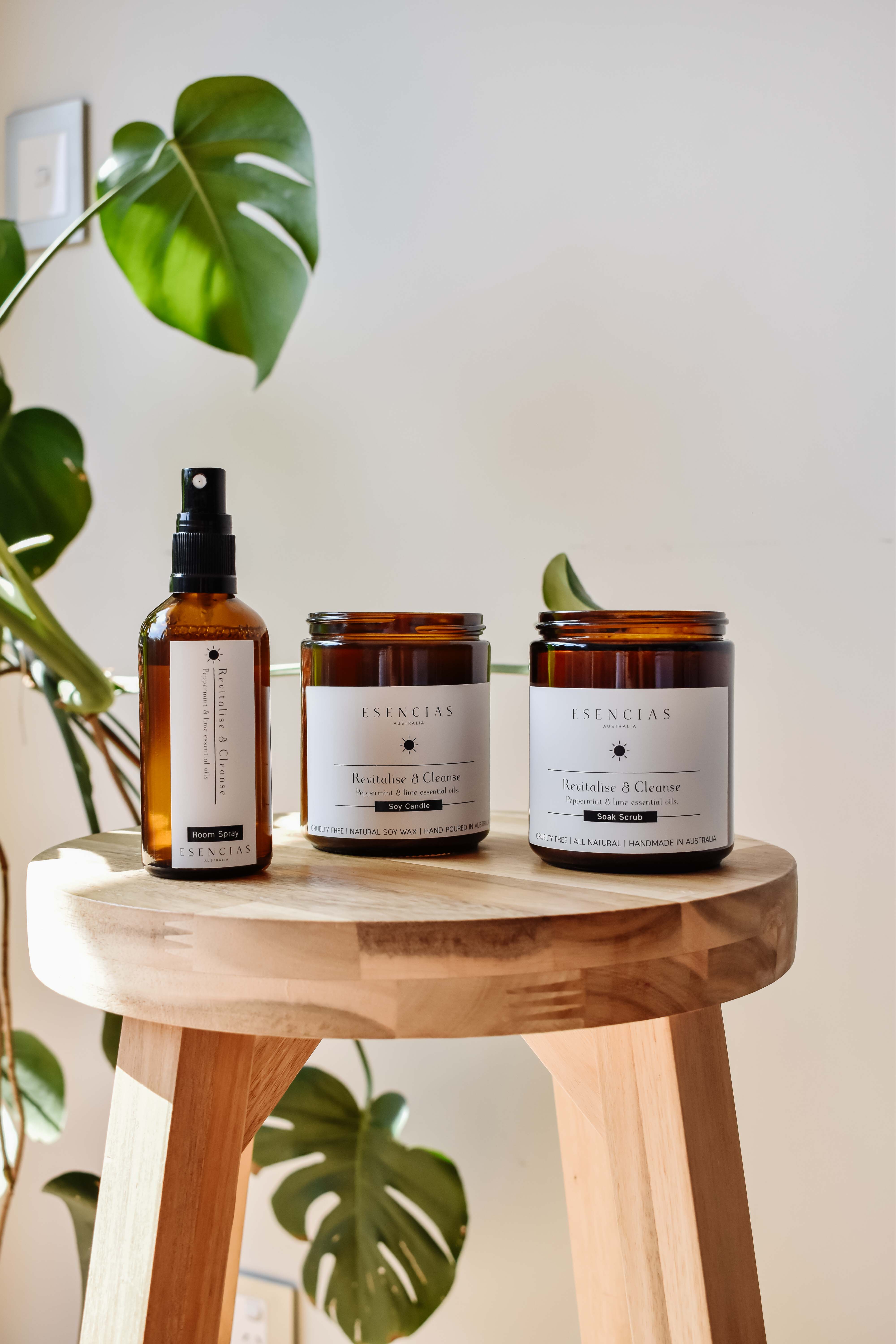 Revitalise and Cleanse candle, room spray and scrub displayed together in a product-focused image, highlighting their clean design and refreshing qualities.