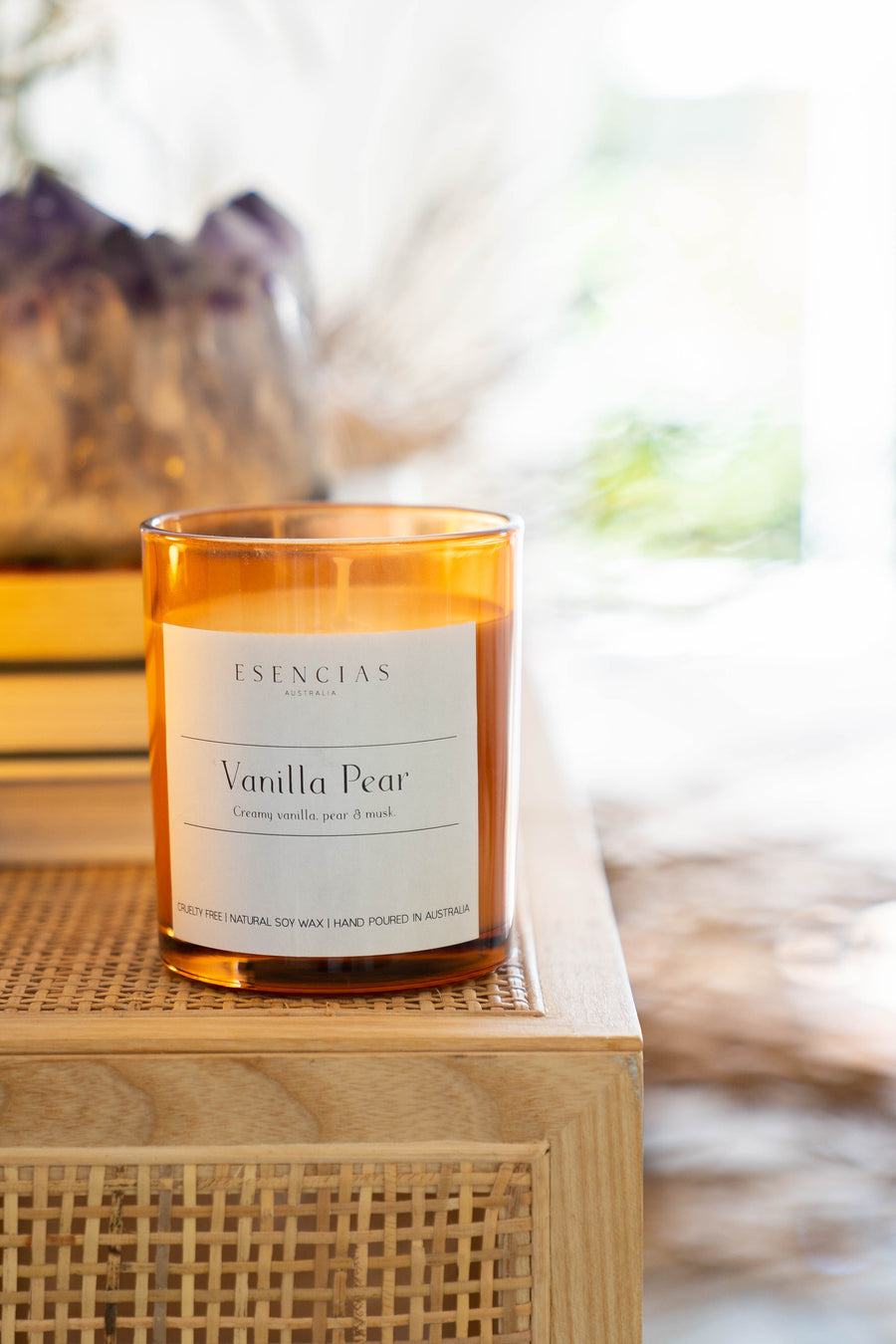 Vanilla Pear candle in amber jar styled in a warm lifestyle setting, evoking comfort and inviting sweetness.