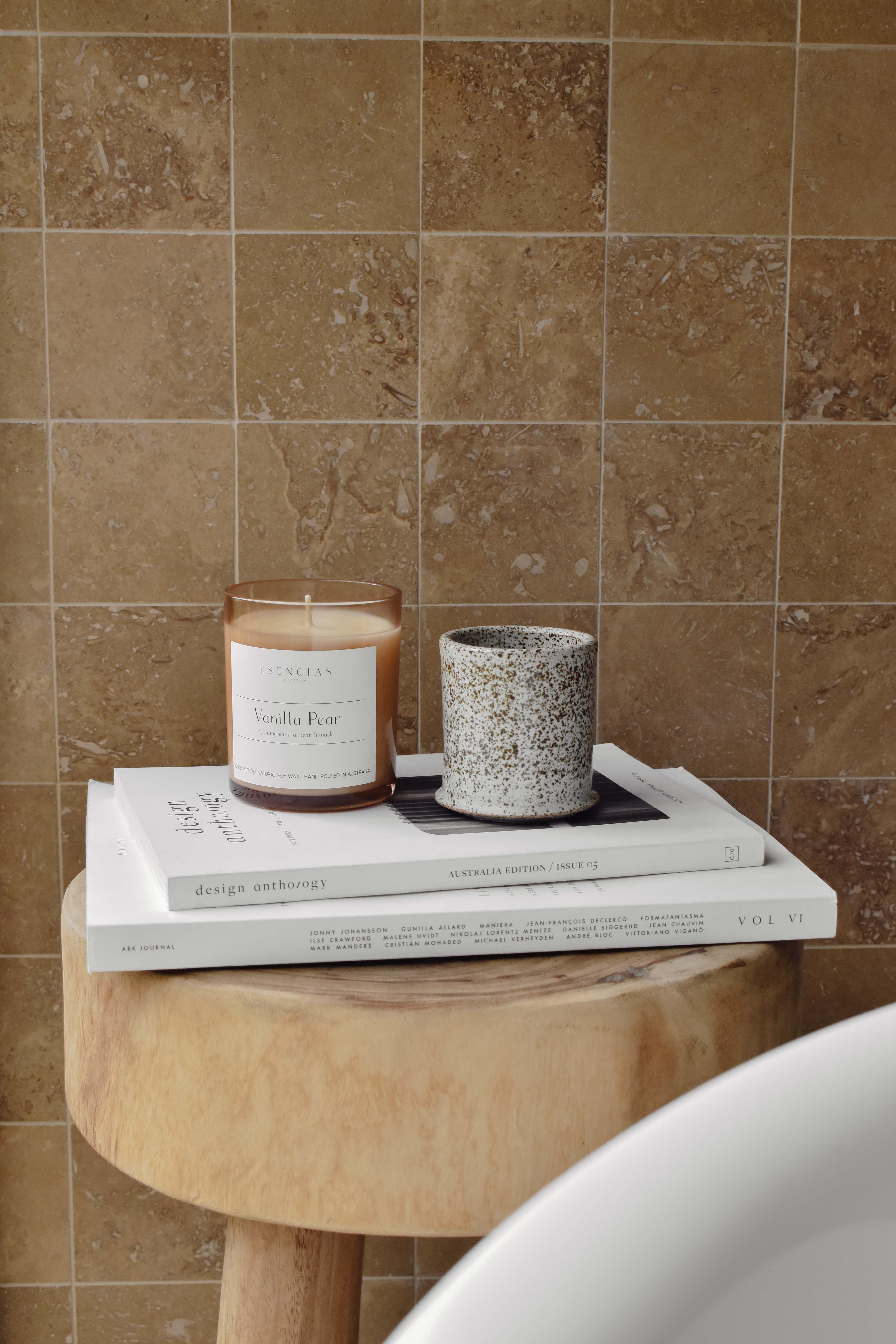 Vanilla Pear candle in amber jar styled in a serene bathroom lifestyle setting, creating a calming and cozy atmosphere.