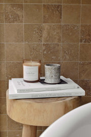 Vanilla Pear candle in amber jar styled in a serene bathroom lifestyle setting, creating a calming and cozy atmosphere.